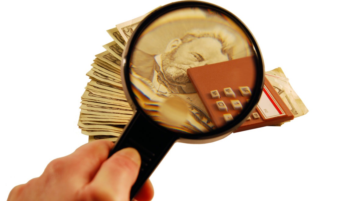 looking through magnifying glass at money - PayReel