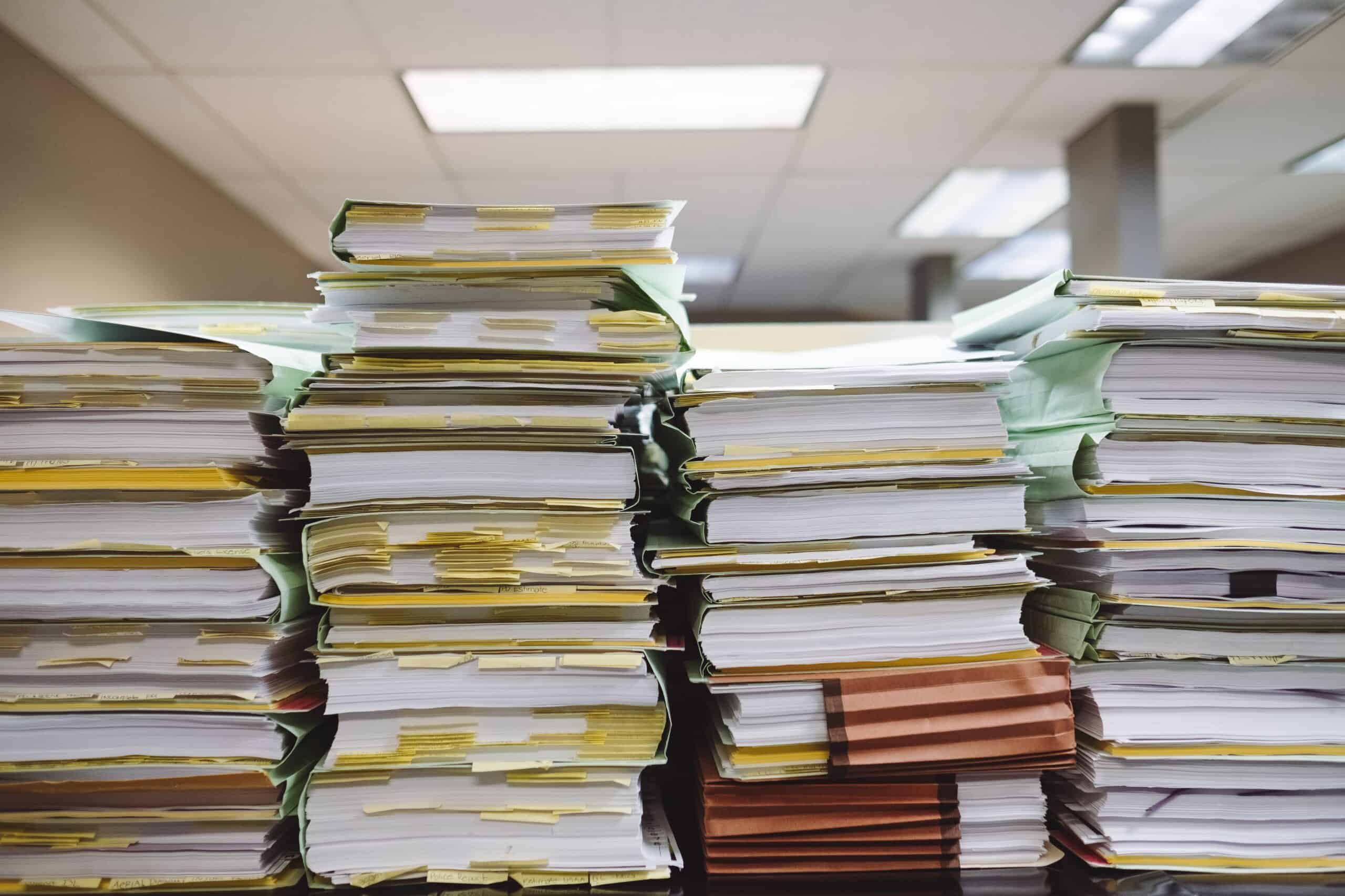 An overwhelming stacked high books and documents