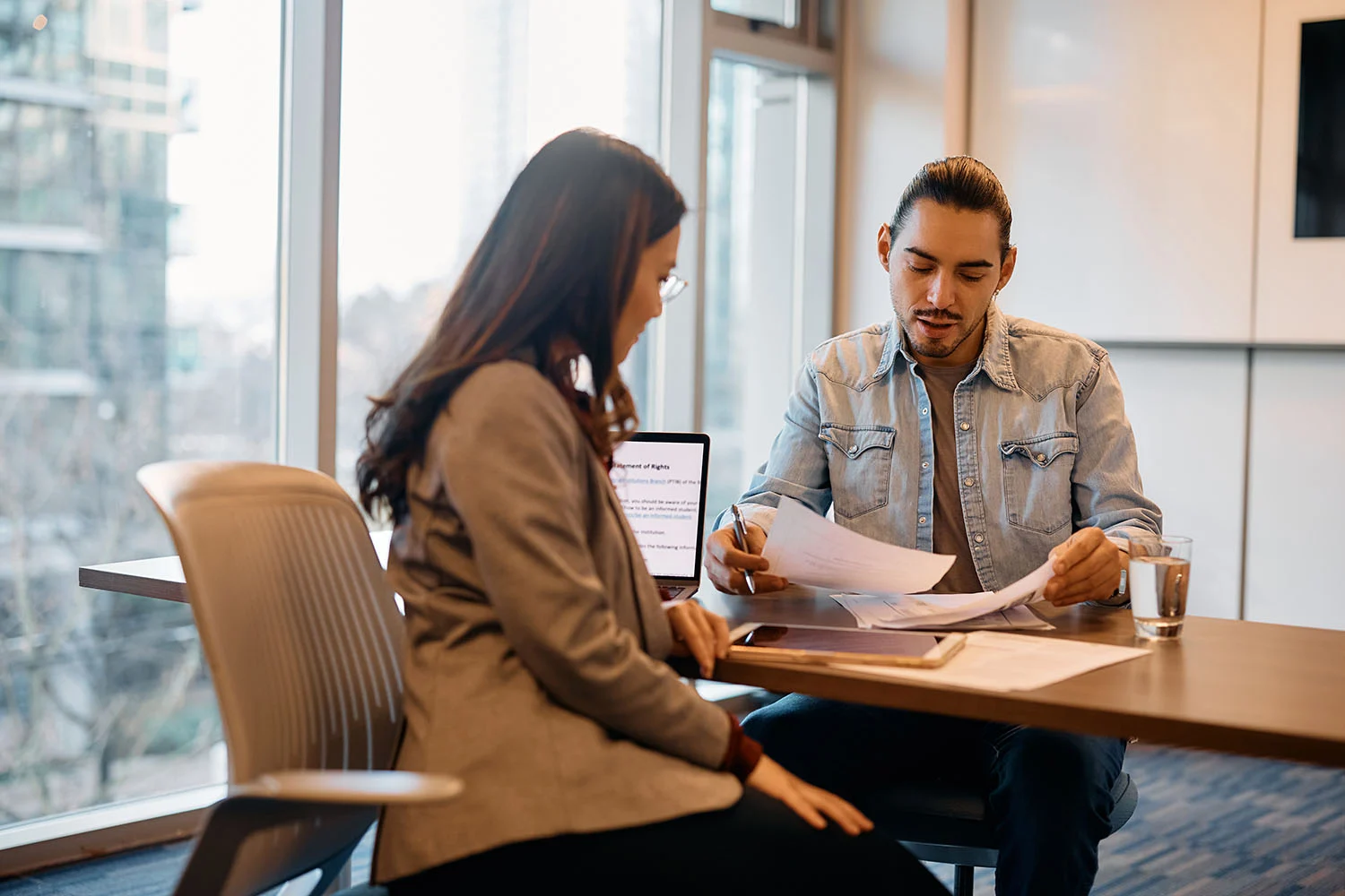 Man and woman in an office having a discussion.