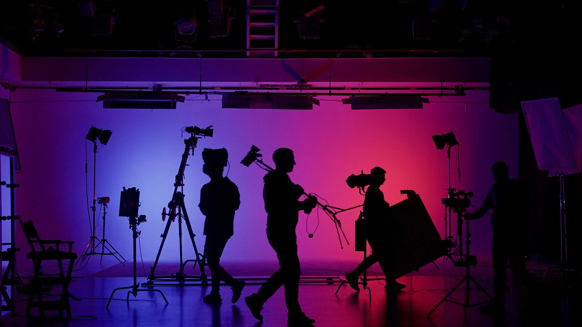 silhouette of people setting up in a studio representing creative media